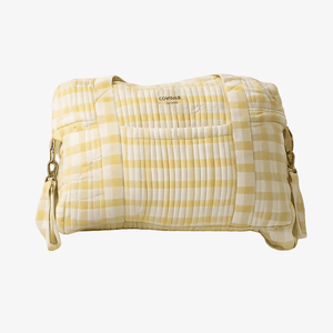 A quilted yellow and white gingham check duffel bag with a top handle, side straps, and a small 'contus' brand label on the front, shown against a plain white background.