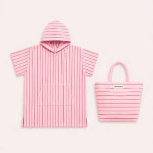 Pink striped poncho with hood and matching tote bag on a light gray background