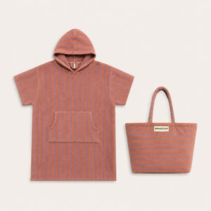 Hooded towel with striped pattern and matching tote bag on a light beige background