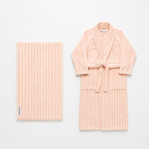 Pink striped robe and towel set on a white background