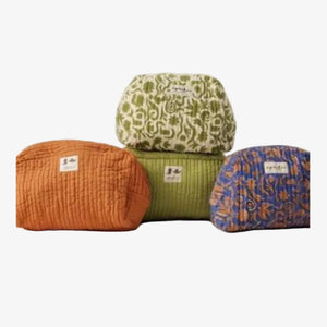 Four quilted fabric pouches or small bags in different colors and patterns, stacked and arranged on a plain light background. The colors include rust orange, green with cream floral pattern, olive green, and blue with orange pattern.